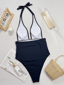 One-piece swimsuit with white deep V-neck halter top and black high-waisted bottom