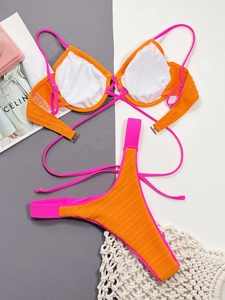 Detailed close-up of orange ribbed bikini with pink trim and underwire support