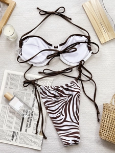 Two-piece white halter bikini set with zebra print bottoms and push-up underwire top