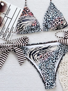 Two-piece bikini set with mixed animal prints, leopard and zebra patterns, side tie bows