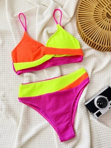Detailed view of neon color-block bikini set with textured waffle fabric and high waist