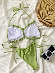 Detailed flat lay of green two-piece bikini showing inner lining and fabric composition labels
