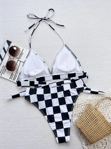 Detailed view of black and white checkered bikini set with halter top and high waist bottom