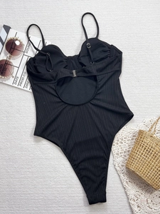 Detailed view of black ribbed one-piece swimsuit with back cutout and high leg cut