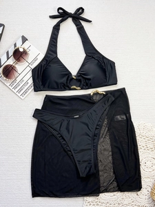 Three-piece black bikini set with gold ring detail and sheer mesh sarong cover-up