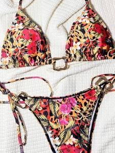 Detail view of leopard and tropical floral print bikini set with golden buckles