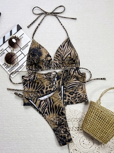Flat lay of a three-piece leopard and zebra print bikini set with matching sarong cover-up