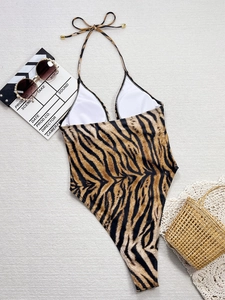 Detailed view of leopard print one-piece swimsuit with halter neck and deep V-neck design
