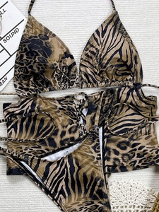 Three-piece bikini set with leopard and tiger print featuring tie-up mesh cover-up wrap