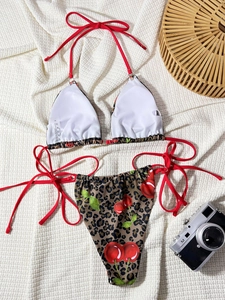 Detail of bikini set fabric label showing material composition and cherry print texture