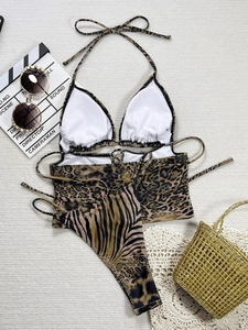 Detailed view of three-piece animal print bikini with leopard and zebra patchwork
