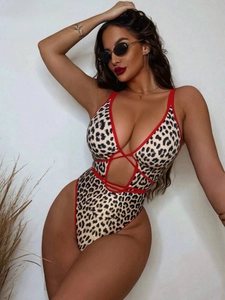 One-piece leopard print swimsuit with deep V-neck, red trim, and criss-cross cutouts