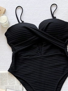 Ribbed black one-piece swimsuit with cutout waist and cross-front pleated details