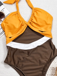 Chic color-block halter bikini set with ruched top and cutout waist in vibrant summer colors