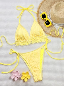 Solid yellow ruffled triangle bikini set with smocked texture and side-tie bottoms