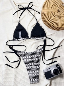 Detailed close-up of a crochet knit bikini set with black and white floral texture