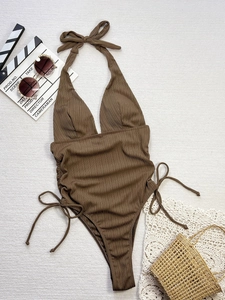 Brown ribbed one-piece swimsuit with deep V-neck and drawstring sides for beach vacation