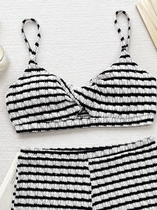Chic black and white striped bikini set with knotted top and seersucker fabric texture