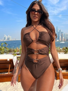 Brown cutout one-piece swimsuit with halter neck and gold rings for a luxury beach look