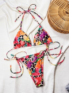 Two-piece triangle bikini set featuring vibrant fruit and leopard mixed print on white fabric