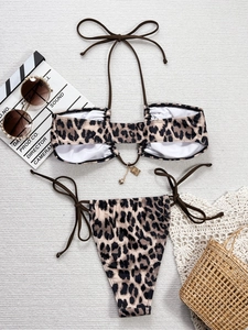 Détail à plat d'un bikini à imprimé léopard avec haut licou et pendentif cœur en métal