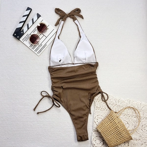 Flat lay of brown ribbed one-piece swimsuit with halter neck and side tie details