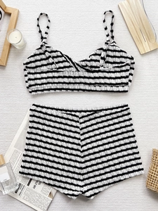 Two-piece black and white striped bikini set with ribbed fabric and high-waisted shorts