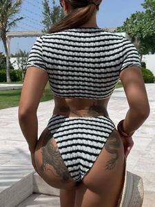 Women's black and white striped two-piece bikini swimsuit with a textured knit fabric
