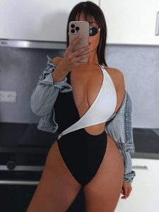 Chic black and white cutout one-piece swimsuit with gold buckle and knit texture