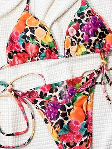 Detail of fabric label on leopard and fruit print bikini showing 82% polyester blend