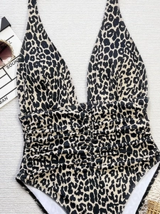 Flat lay of leopard print deep V-neck one-piece swimsuit with ruched waist detail