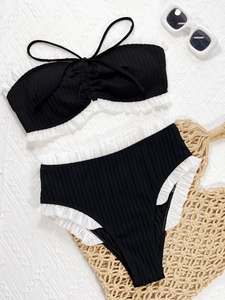 Two-piece ribbed bikini set in black and white with ruffled trim and high waist