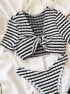 Two-piece black and white striped bikini set with short sleeve twist knot top and high cut bottom