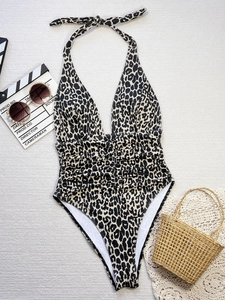 Detailed flat lay of leopard print deep V one-piece swimsuit with ruching and neck ties
