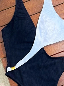 Monochrome cutout one-piece swimsuit with textured fabric and gold metal buckles