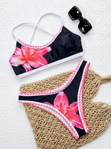 Detailed flat lay of floral print high waist bikini set with cross back strap design