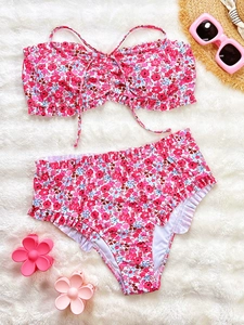 Close-up of floral bikini set with ruffle edges and drawstring on white plush background