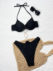 Detail of ribbed black bikini featuring three gold metal rings and lace-up neck design