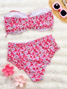 Detailed view of floral bikini set with ruffled edges on soft faux fur background