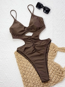 Dark brown one-piece swimsuit with cutout waist and ruched detailing for beach vacation