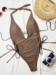Deep brown V-neck one-piece swimsuit with metal ring detail and halter neck strap