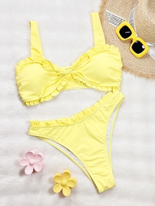 Two-piece bright yellow ruffle bikini set with high waist bottom and summer accessories