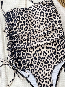 One-piece leopard print bikini swimsuit with ruched sides and adjustable ties