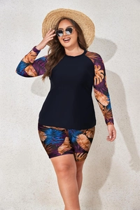 Detail of plus size long sleeve swimsuit with vibrant tropical leaf prints and high waist bottom