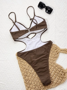 Brown one-piece monokini swimsuit with cut-out waist and thin straps on white background