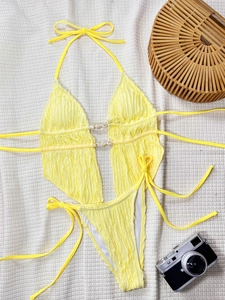 Détail du bikini jaune texturé avec boucles marbrées et bas de maillot à nouer sur les côtés