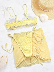 Three-piece pale yellow bikini set with ruffle edges and matching mesh sarong wrap