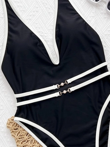 Chic black deep V-neck one-piece swimsuit with white contrast trim and pearl waist detail