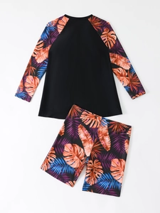Detail of long sleeve rash guard and tropical print swim shorts in high-stretch fabric