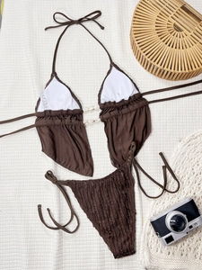 Vue détaillée d'un bikini marron foncé avec accents de coquillages et tissu côtelé